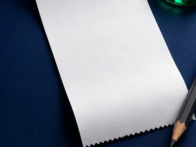 Paper bet slip next to a pen and a chip